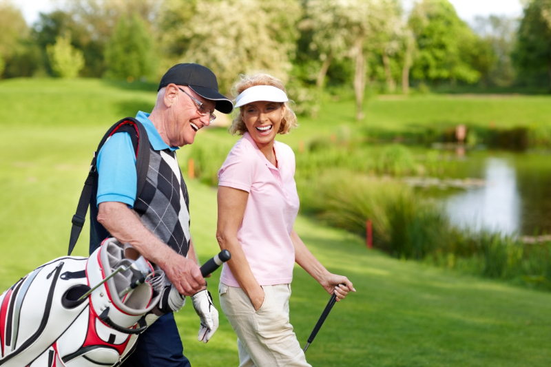 senior couple laughing on the golf field